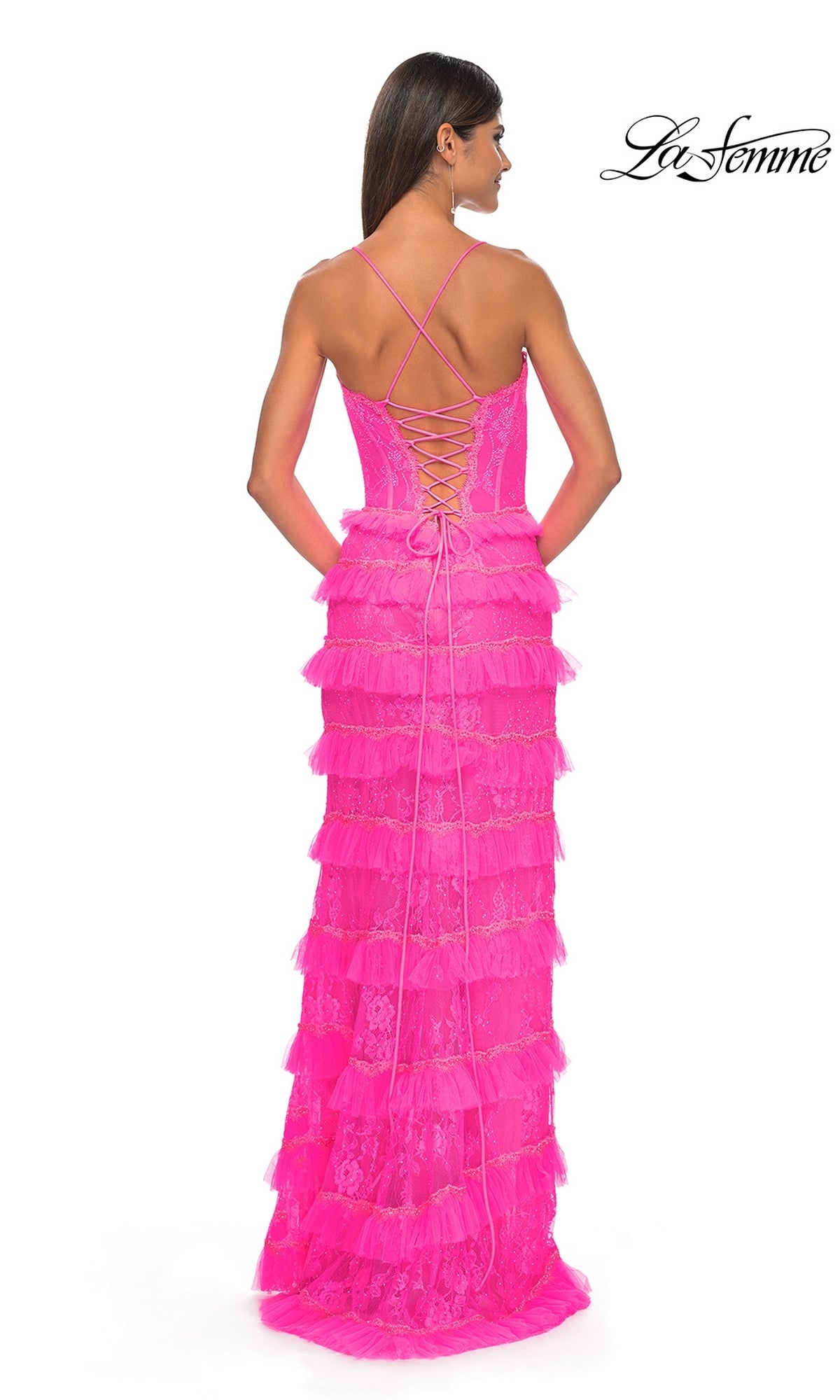 Woman seen from behind wearing a bright pink Ruffled Long Beaded-Lace Prom Dress (La Femme 32442) with lace and a crisscross lace-up back.